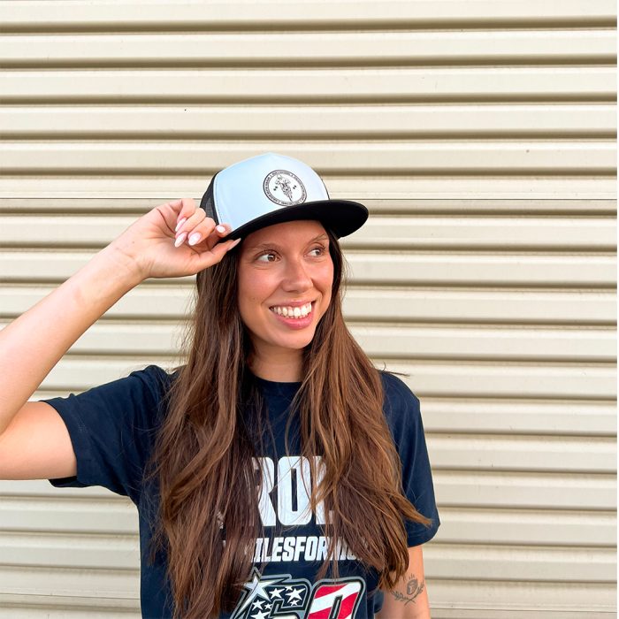 Female model wearing the Rider Support Trucker Hat